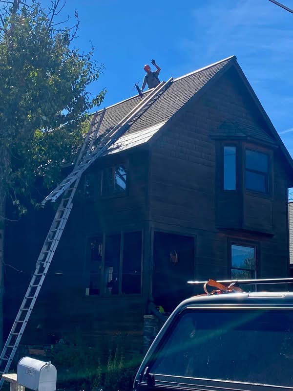 Working along the ridge of a steep roof.