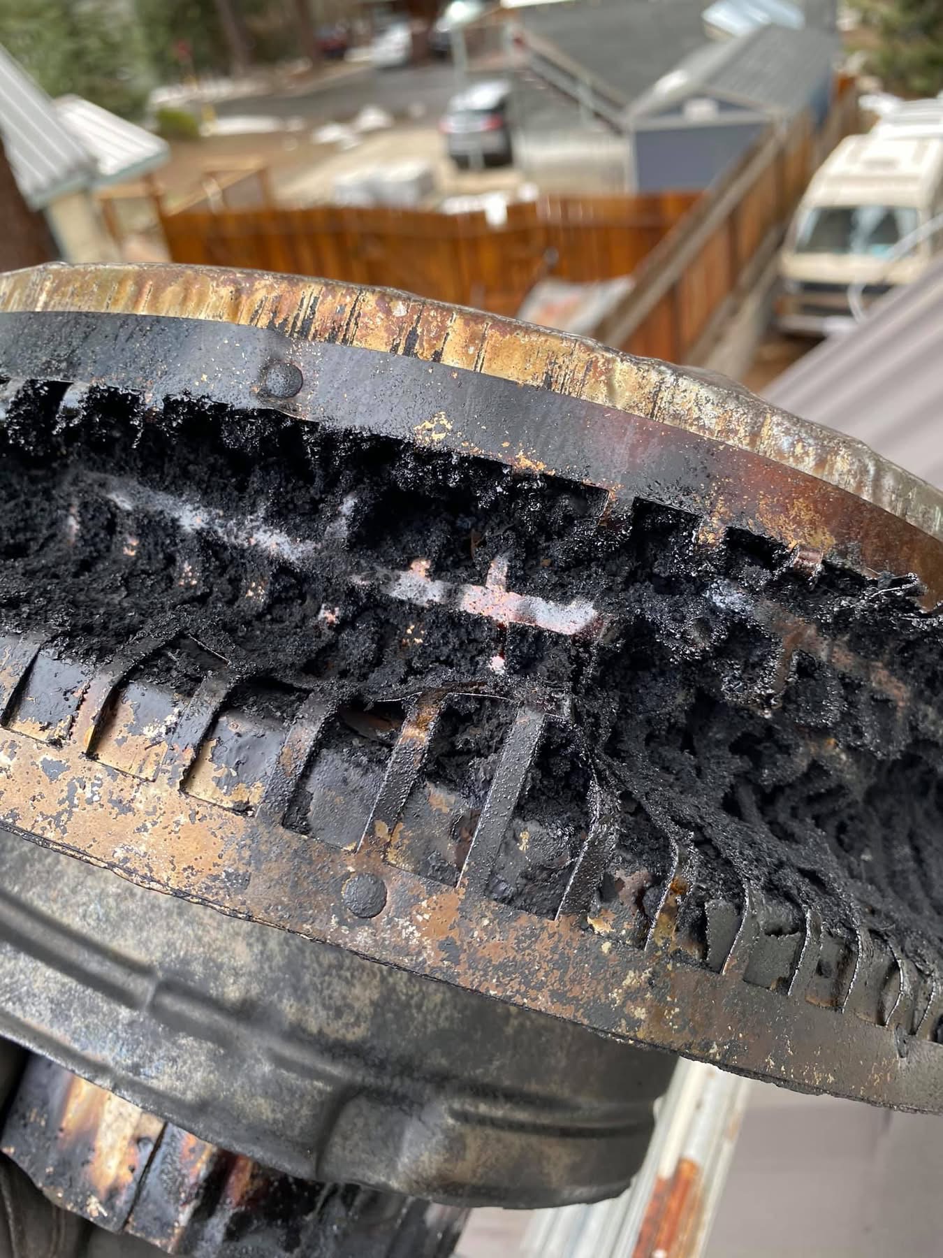 A close-up of buildup on a chimney cap.